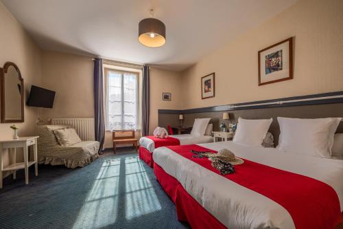 a bedroom with a large bed and a large window at Auberge De Kerveoc'h in Douarnenez