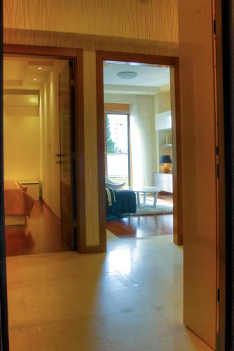 an open door to a living room with a couch at Apartments Athos in Podgorica