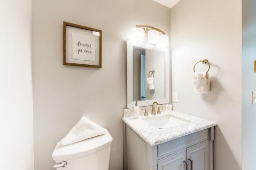 a white bathroom with a sink and a toilet at Watch Hill Lofted in Silverthorne