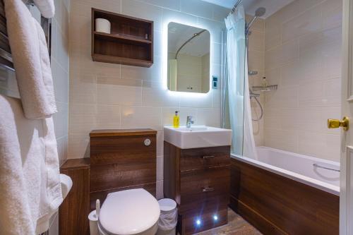 a bathroom with a toilet and a sink and a shower at The White Hart Hotel, Boston, Lincolnshire - The Coaching Inn Group in Boston
