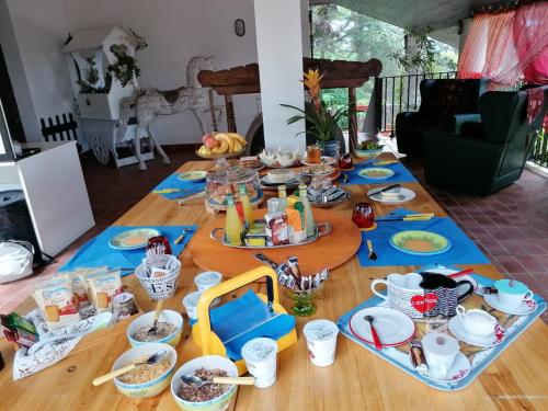 een tafel met eten en gerechten erop bij Il Giardino di Mai Exclusive B&b in Montabone