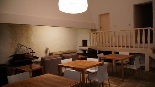 a room with tables and chairs and a staircase at Casa Abrigo do Lagar in Amares