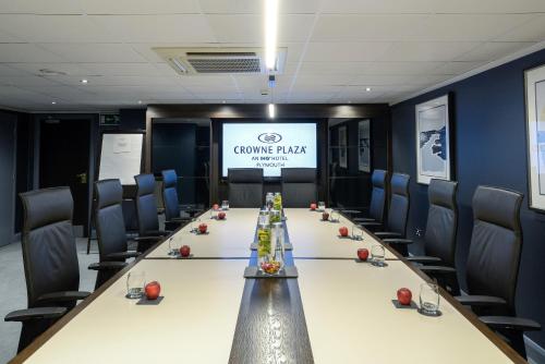 a conference room with a long table and chairs at Crowne Plaza Plymouth by IHG in Plymouth