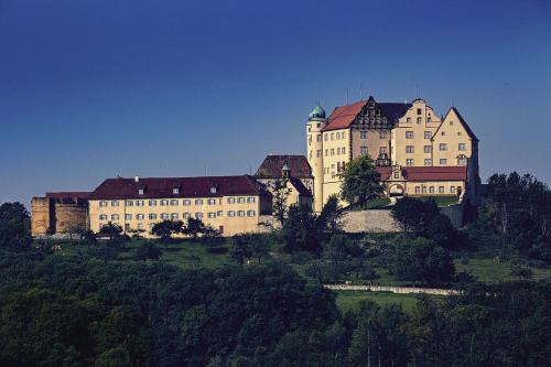 a large building sitting on top of a hill at Apartment in Stauseenähe in Rainau