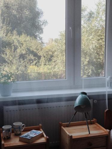 a lamp sitting on a table in front of a window at Noclegi Jachtklub Elbląg in Elblag