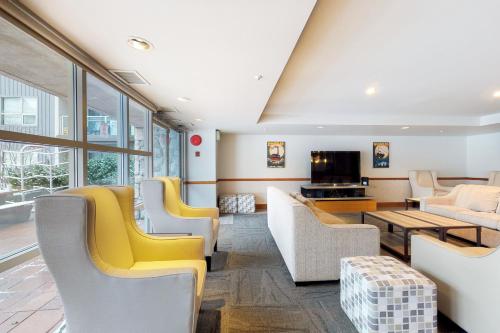 a living room with couches and a tv at The Aspens on Blackcomb in Whistler