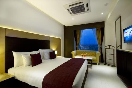a hotel room with a large bed and a television at The Fern Residency - Chandigarh in Chandīgarh