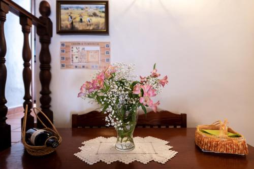 a vase of flowers sitting on a table at Casa Elba in Isora