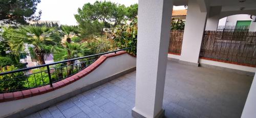 a balcony of a house with palm trees and plants at Residence Dei Fiori in Pietra Ligure