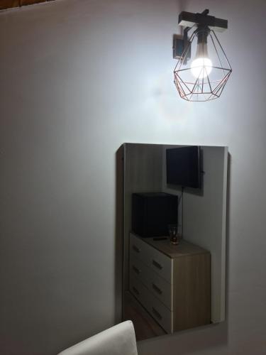a room with a tv and a dresser with a mirror at B&B Villa Chiara - Bed And Breakfast in Taormina