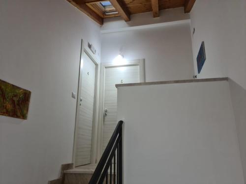 a hallway with a staircase and a white door at B&B Villa Chiara - Bed And Breakfast in Taormina