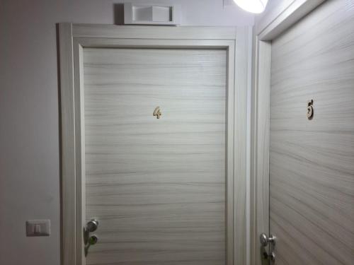 a white door with two locks on it at B&B Villa Chiara - Bed And Breakfast in Taormina
