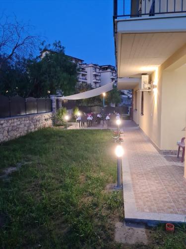 a backyard at night with lights on the grass at B&B Villa Chiara - Bed And Breakfast in Taormina