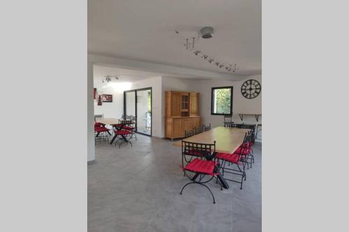 une salle à manger avec des chaises rouges et une table dans l'établissement LA LOGIA DU PEUPLIER, à Rilly-la-Montagne