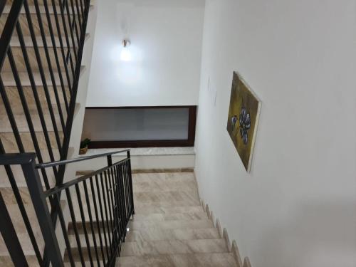 a hallway with a staircase with a bench on the wall at B&B Villa Chiara - Bed And Breakfast in Taormina