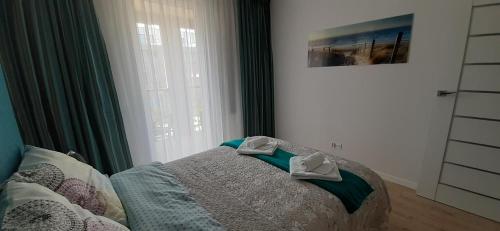 Ein Bett oder Betten in einem Zimmer der Unterkunft Turkusowe Marzenie