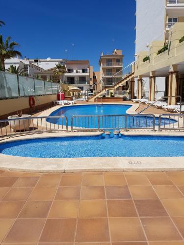 a swimming pool in the middle of a building at O7 Nordeste Playa in Can Picafort