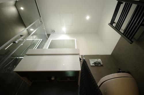 a bathroom with a white sink and a toilet at La casita de Sofi in Facinas