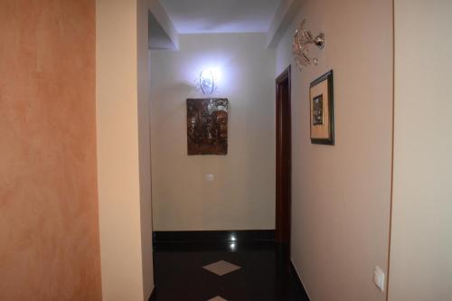 a hallway with a door and paintings on the wall at Villa Mia Suites in Ohrid