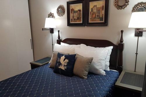 a bedroom with a bed with pillows and two lamps at Sarnia's Hidden Gem - 3 BR/2 BA by College/Hwy/Arena in Sarnia