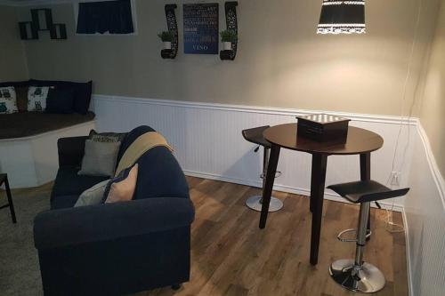 a living room with a couch and a table at Sarnia's Hidden Gem - 3 BR/2 BA by College/Hwy/Arena in Sarnia