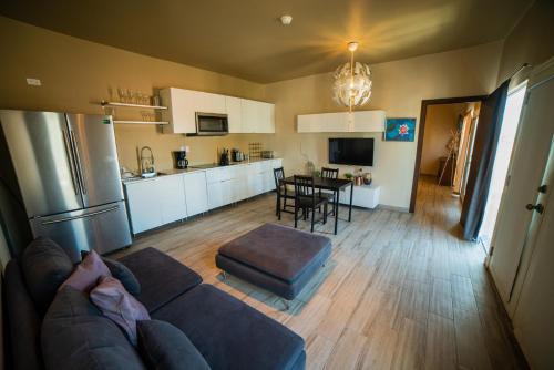 a living room with a couch and a kitchen at California Comfort & Suites in Los Algodones