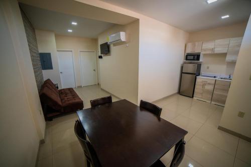 a kitchen and dining room with a table and chairs at California Comfort & Suites in Los Algodones