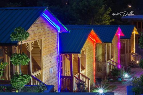 a house with colorful lights on it at night at Villa Edemi in Tskaltubo