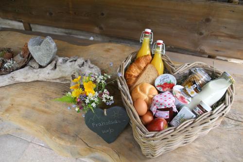 a basket of bread and fruit on a table at Salzgeber Appartements in Sankt Gallenkirch