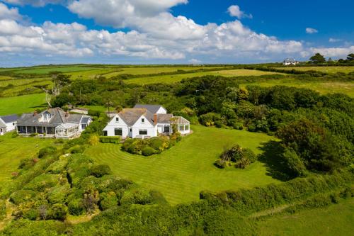 an aerial view of a house on a green field at Trerhose B&B in Mullion