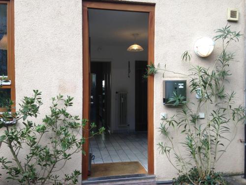 an open door of a house with plants at Haus Schönwald in Freiburg im Breisgau
