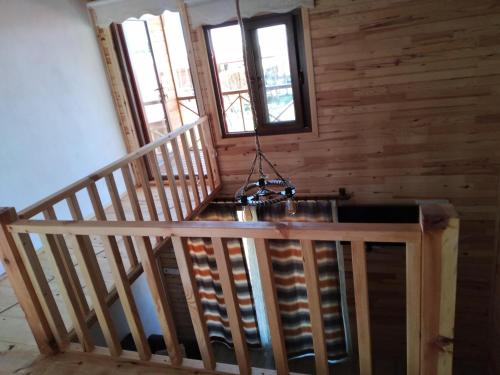 a staircase with a chandelier in a wooden cabin at EM-BA BUTİK BUNGALOV in Demre