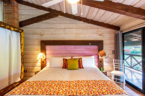 a bedroom with a large bed in a room at Latica Lodge in Playa Negra