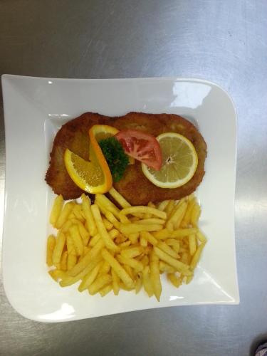 a plate of food with fish and french fries at Hotel-Café-Burg Stahleck in Bacharach