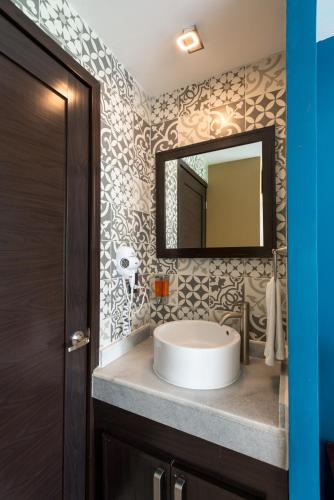 a bathroom with a sink and a mirror at RESTYLE: Ocean front + pool Nuevo Vallarta in Nuevo Vallarta