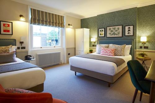 A bed or beds in a room at Lime Tree Hotel