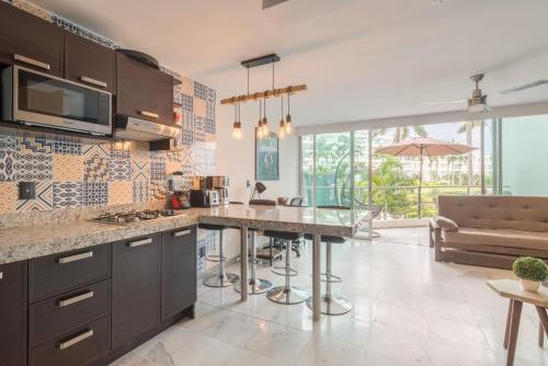 a kitchen with a large island in a room at RESTYLE: Ocean front + pool Nuevo Vallarta in Nuevo Vallarta 