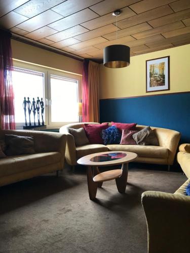 a living room with two couches and a coffee table at fun4all-holidayhome in Medebach