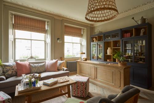 a living room filled with furniture and a window at Lime Tree Hotel in London