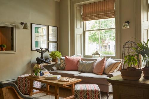 a living room with a couch and a table at Room Mate Lime Tree in London