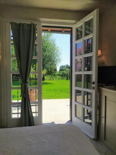 a bedroom with a door open to a yard at B&B La Limonaia in Pietrasanta