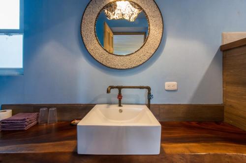 a bathroom with a sink and a mirror at Latica Lodge in Playa Negra