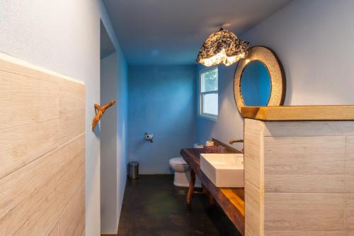 a bathroom with a sink and a toilet at Latica Lodge in Playa Negra