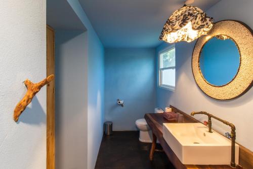 a bathroom with a sink and a mirror at Latica Lodge in Playa Negra