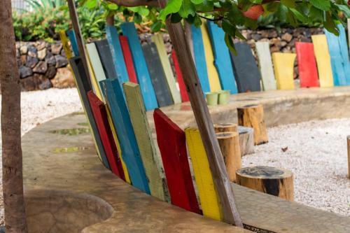 a row of colorful books leaning against a fence at Latica Lodge in Playa Negra
