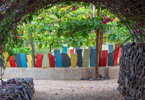 a group of colorful pillows sitting on a bench at Latica Lodge in Playa Negra