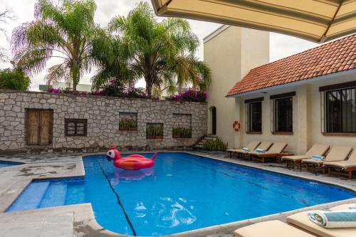 a swimming pool with a red rubber duck in the middle at Hotel Flamingo Inn in Querétaro
