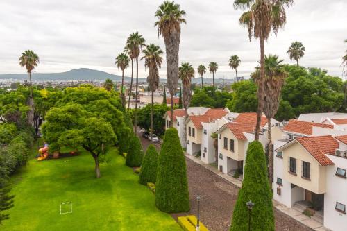 an aerial view of a residential neighborhood with palm trees and houses at Hotel Flamingo Inn in Querétaro