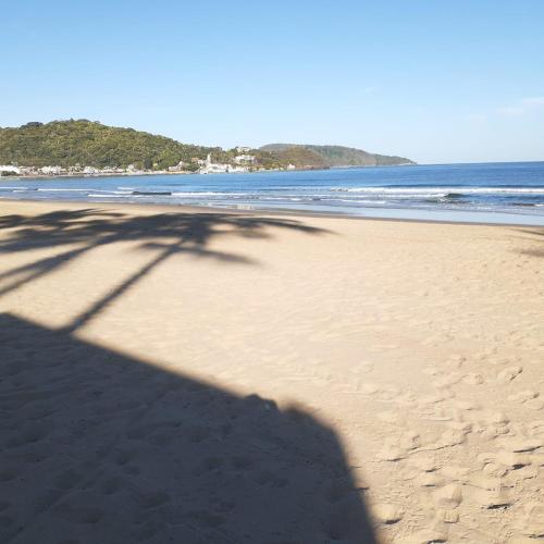 a shadow of a tree on the beach at Bungalows Maria Teresa in Rincon de Guayabitos