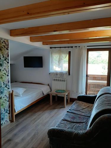 a bedroom with a bed and a couch at MON AMI in Sărata-Monteoru